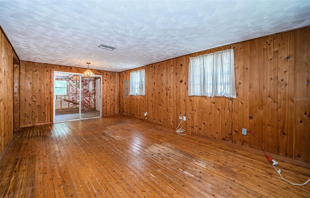 6423 Bass Road Weeki Wachee, FL 34607 - Photo 10 of 49 wooden floor in an empty room with a window