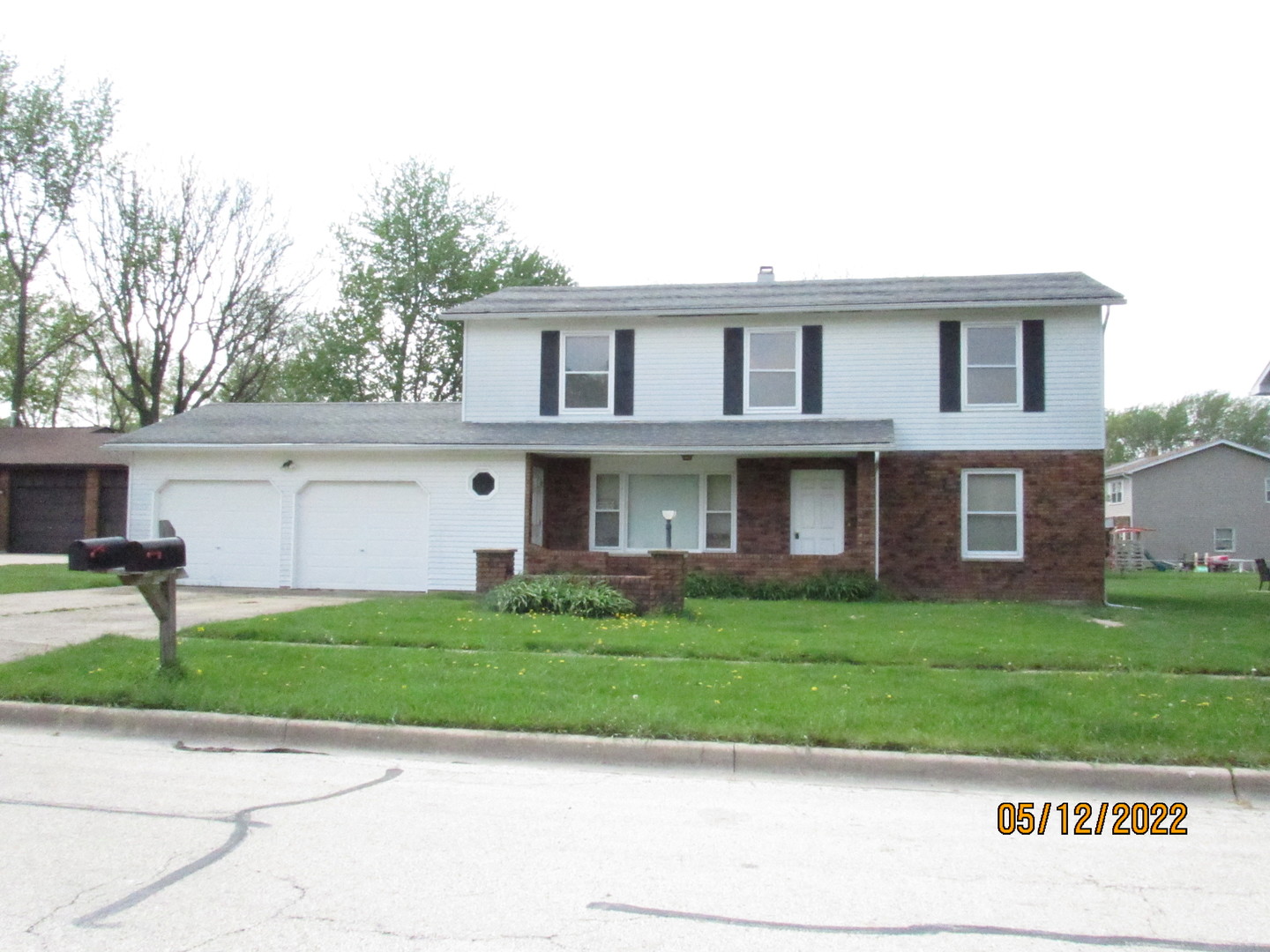 a view of a brick house with a yard