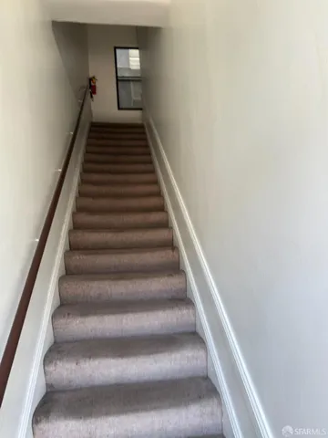 a bedroom with bed and a view of kitchen