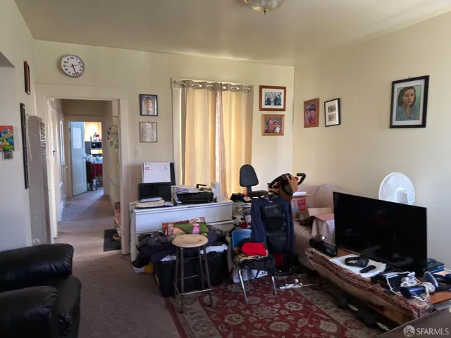 a bedroom with a bed tv and a mirror