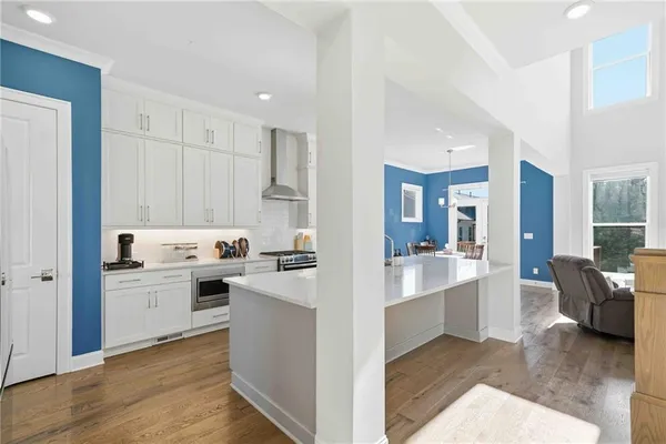a kitchen with cabinets and wooden floor