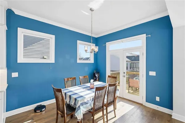 a living room with furniture wooden floor and a table