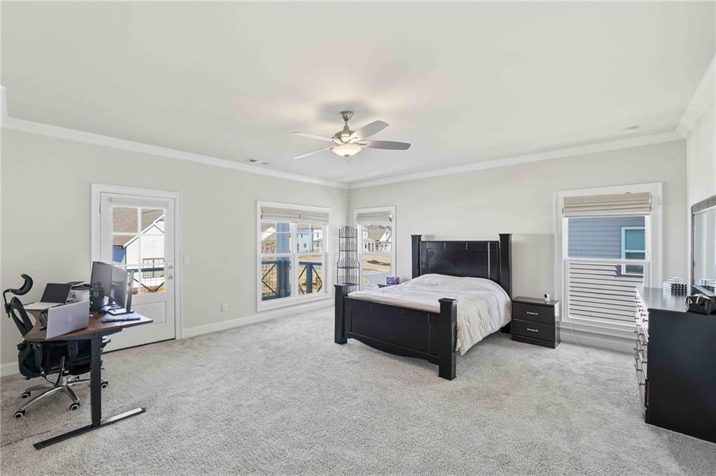 303 McDaniel Place Canton, GA 30115 - Photo 29 of 53 a spacious bedroom with a bed and a chandelier