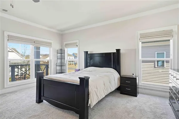 a spacious bedroom with a bed and ceiling fan