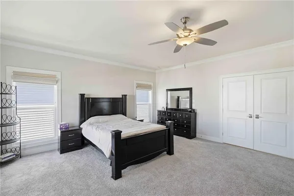 a bedroom with a bed and a large window