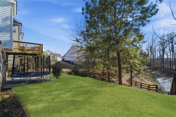 a view of a roof deck with chair and wooden floor
