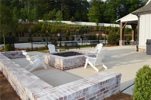 a view of swimming pool with outdoor seating and plants