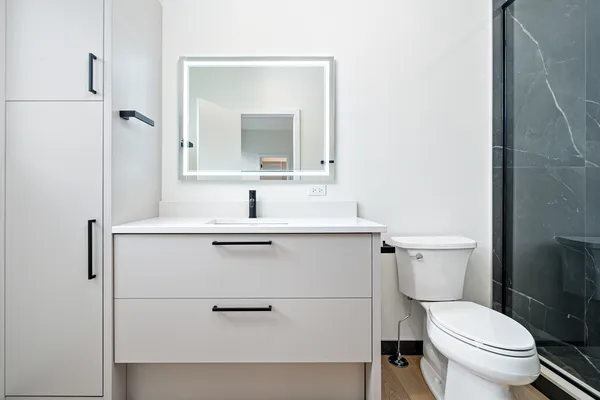 a bathroom with a toilet and a shower