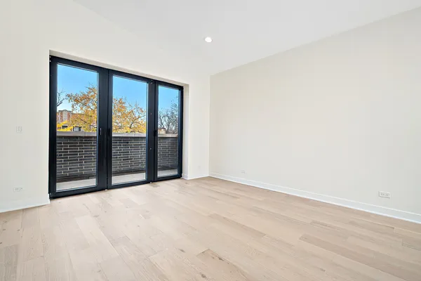 an empty room with sliding door and windows