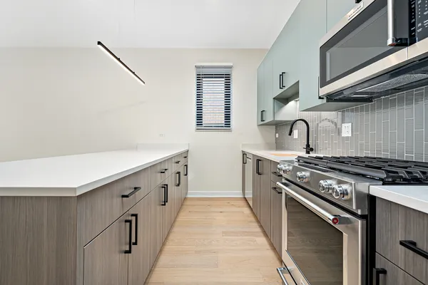 a view of kitchen with stainless steel appliances granite countertop cabinets and a refrigerator