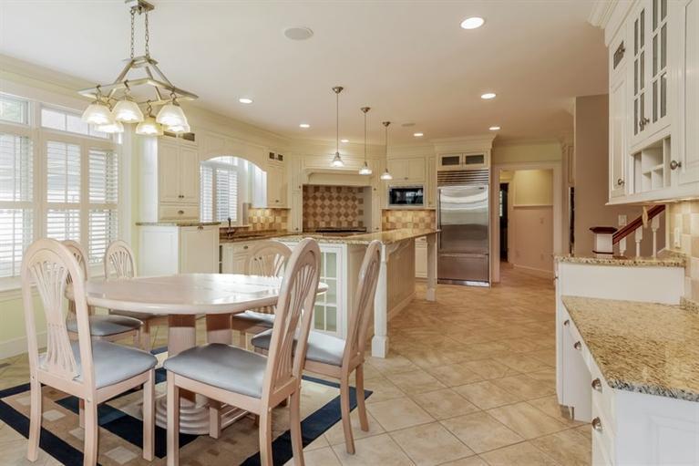 85 Seapuit Road Osterville, MA 02655 - Photo 6 of 22 a dining room with stainless steel appliances kitchen island granite countertop a table chairs and a chandelier