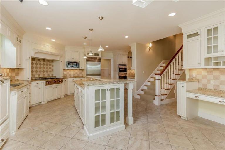 85 Seapuit Road Osterville, MA 02655 - Photo 8 of 22 a kitchen with stainless steel appliances kitchen island granite countertop a stove a sink and a refrigerator