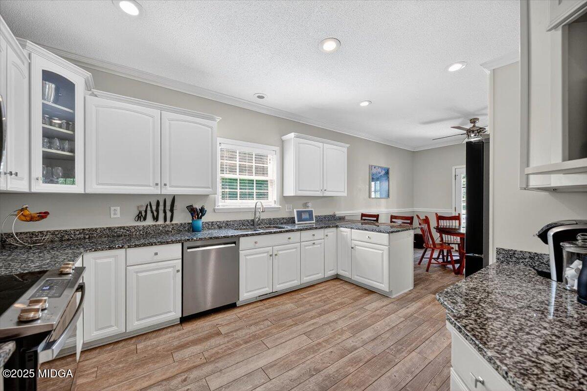 9481 Hopewell Road Musella, GA 31066 - Photo 14 of 72 a kitchen with a sink stove cabinets and wooden floor
