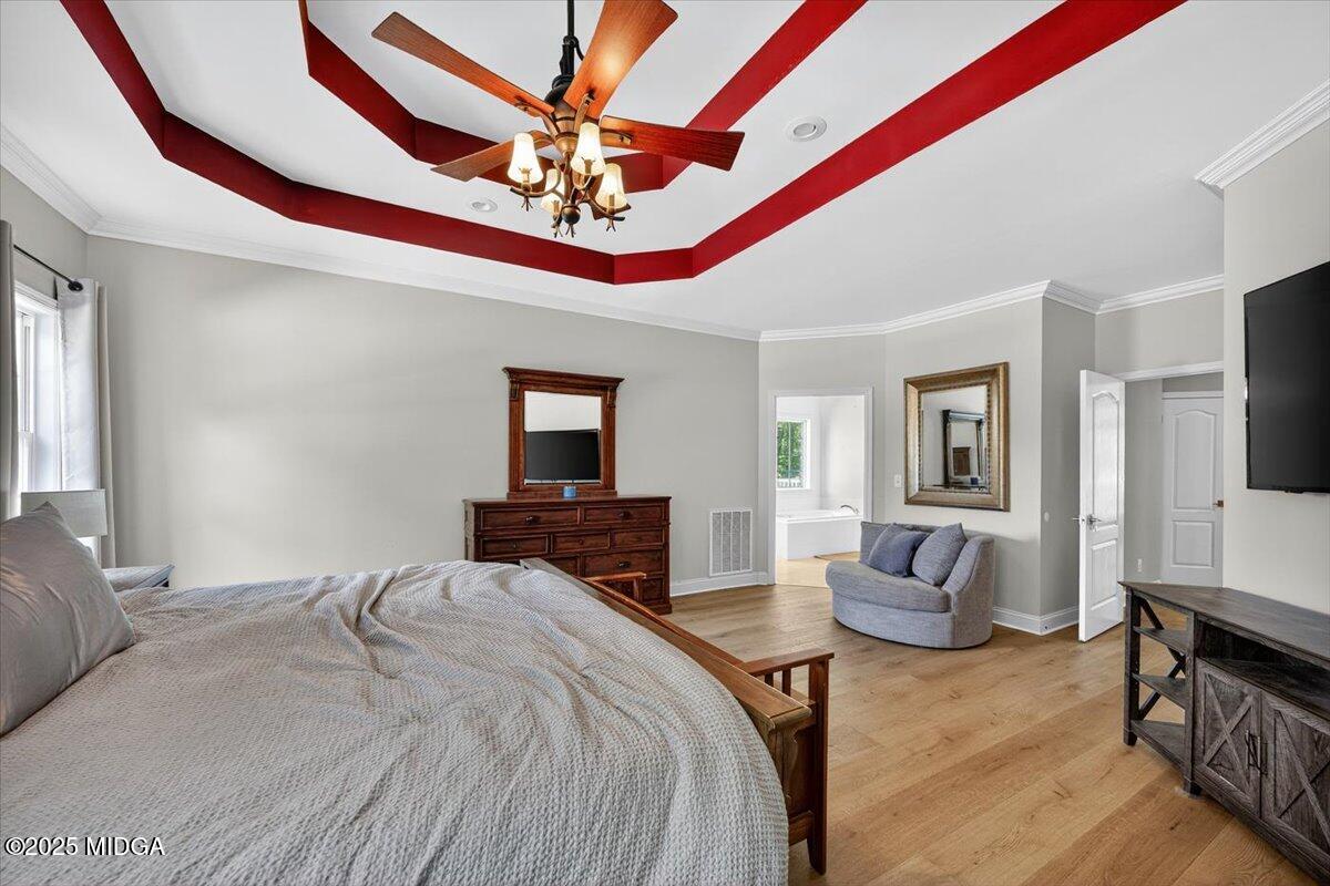 9481 Hopewell Road Musella, GA 31066 - Photo 20 of 72 a bedroom with a bed and a chandelier
