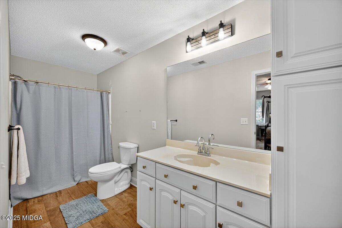 9481 Hopewell Road Musella, GA 31066 - Photo 30 of 72 a bathroom with a sink toilet a mirror and shower