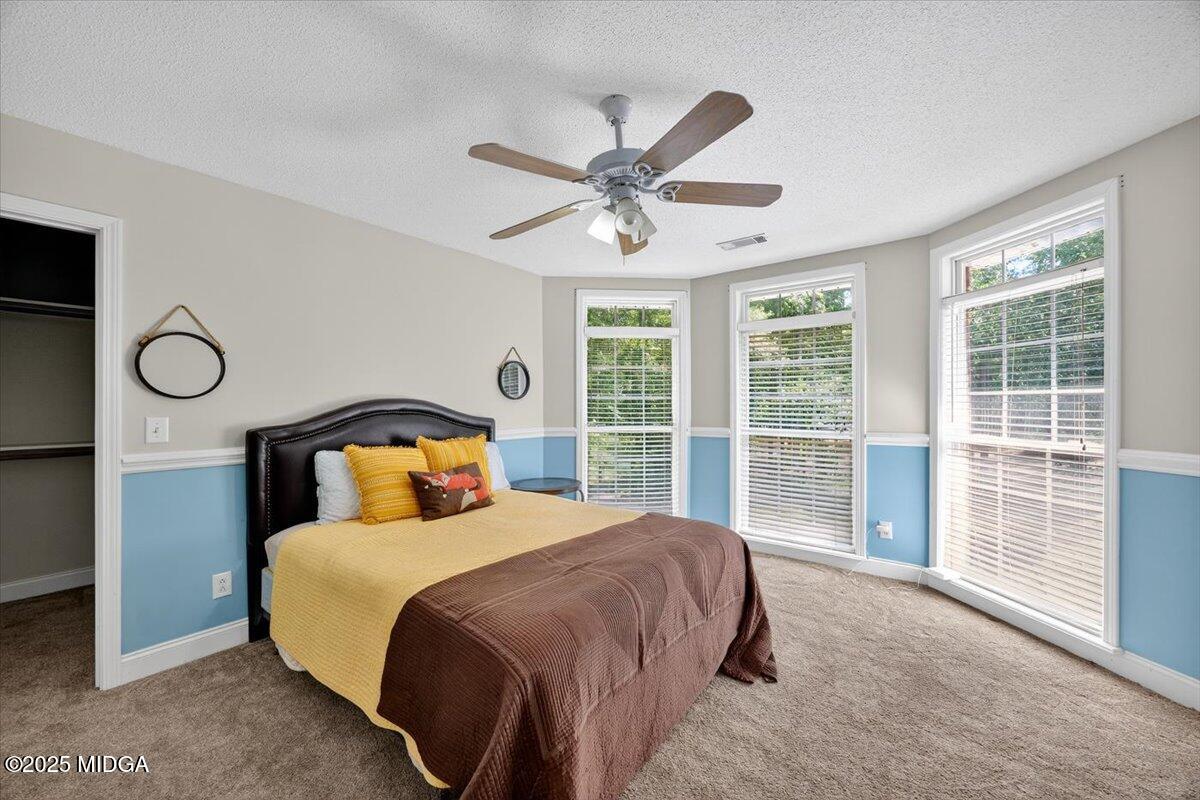 9481 Hopewell Road Musella, GA 31066 - Photo 31 of 72 a bedroom with a large bed and a large window