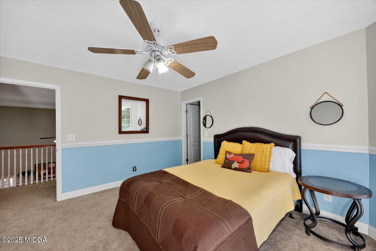 9481 Hopewell Road Musella, GA 31066 - Photo 32 of 72 a bedroom with a bed and a chandelier