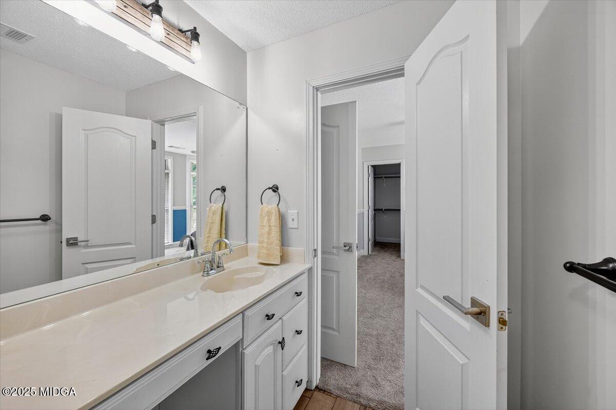 9481 Hopewell Road Musella, GA 31066 - Photo 33 of 72 a bathroom with a double vanity sink and a mirror