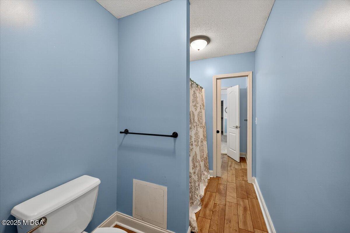 9481 Hopewell Road Musella, GA 31066 - Photo 34 of 72 a bathroom with a toilet and a shower