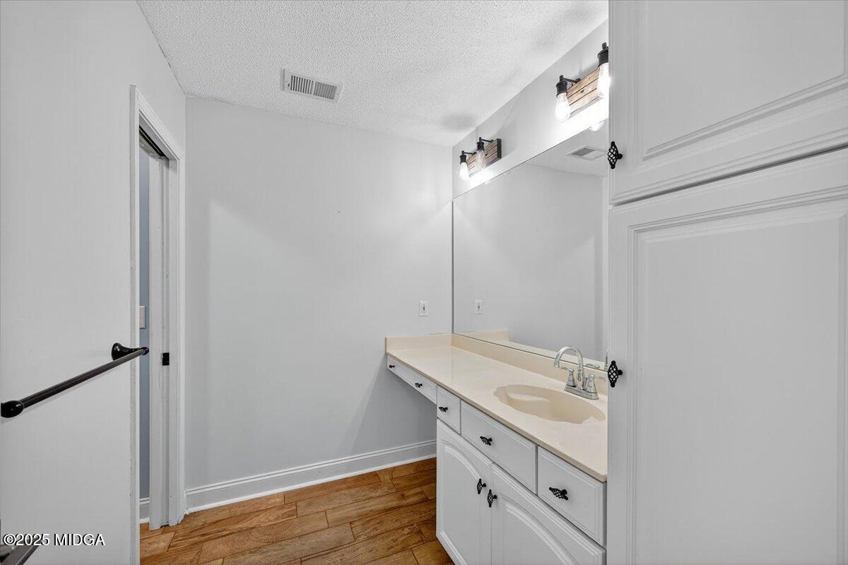 9481 Hopewell Road Musella, GA 31066 - Photo 35 of 72 a bathroom with a sink mirror and shower