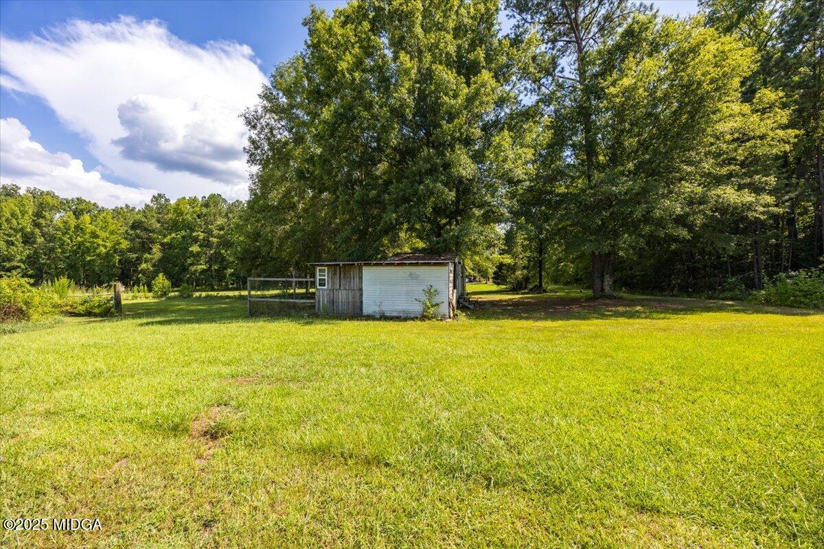 9481 Hopewell Road Musella, GA 31066 - Photo 65 of 72 a view of a swimming pool with an outdoor space and seating area
