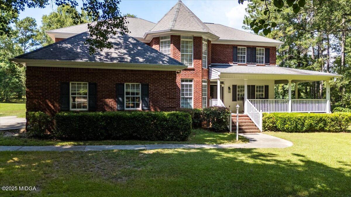 9481 Hopewell Road Musella, GA 31066 - Photo 69 of 72 a front view of a house with a garden