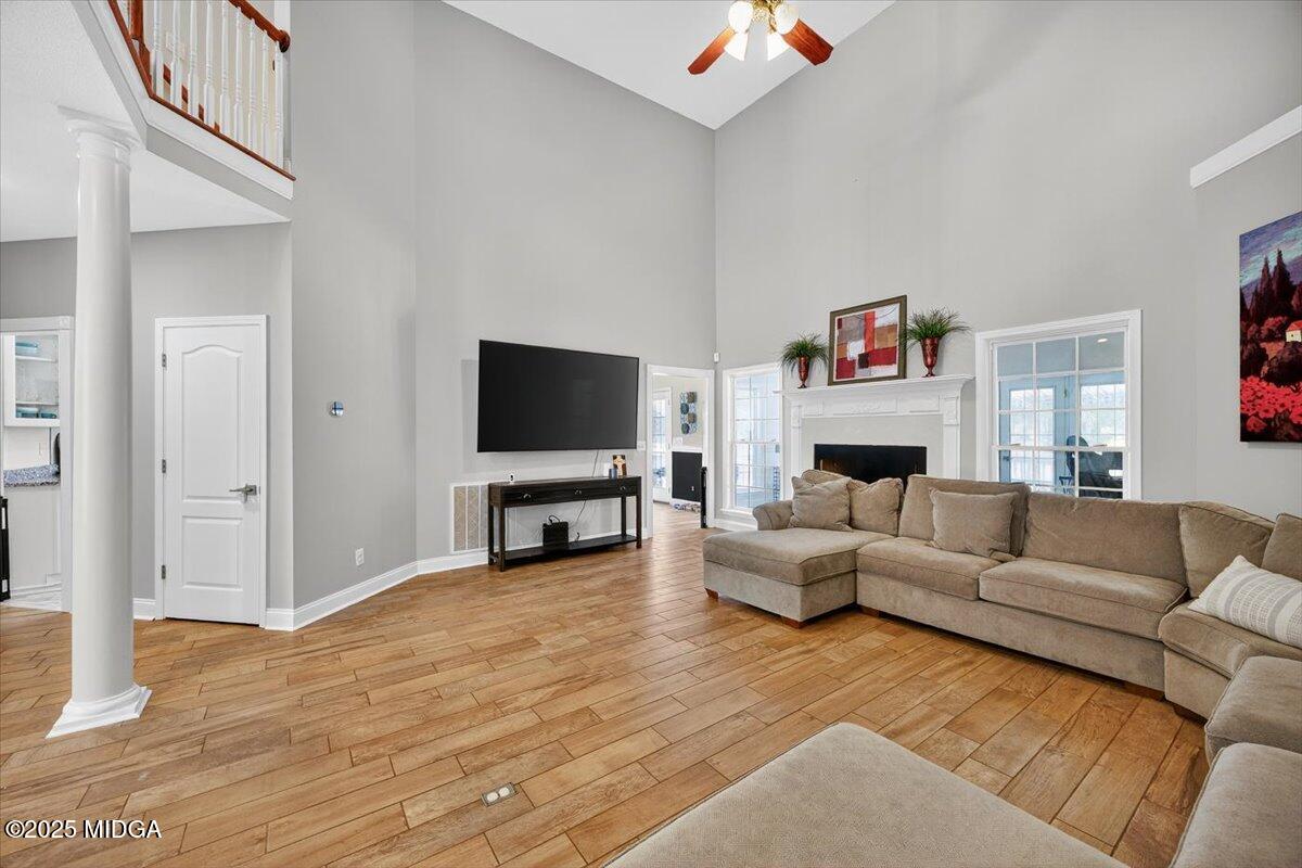 9481 Hopewell Road Musella, GA 31066 - Photo 7 of 72 a living room with furniture a fireplace and a flat screen tv