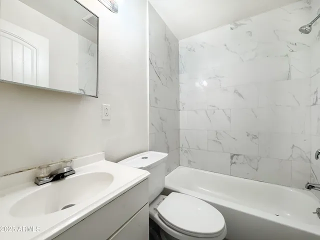 a bathroom with a sink toilet and bathtub