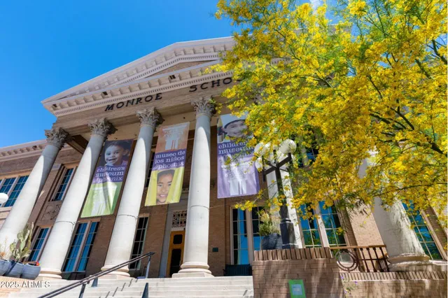 a front view of multi story building with retail shop and large windows
