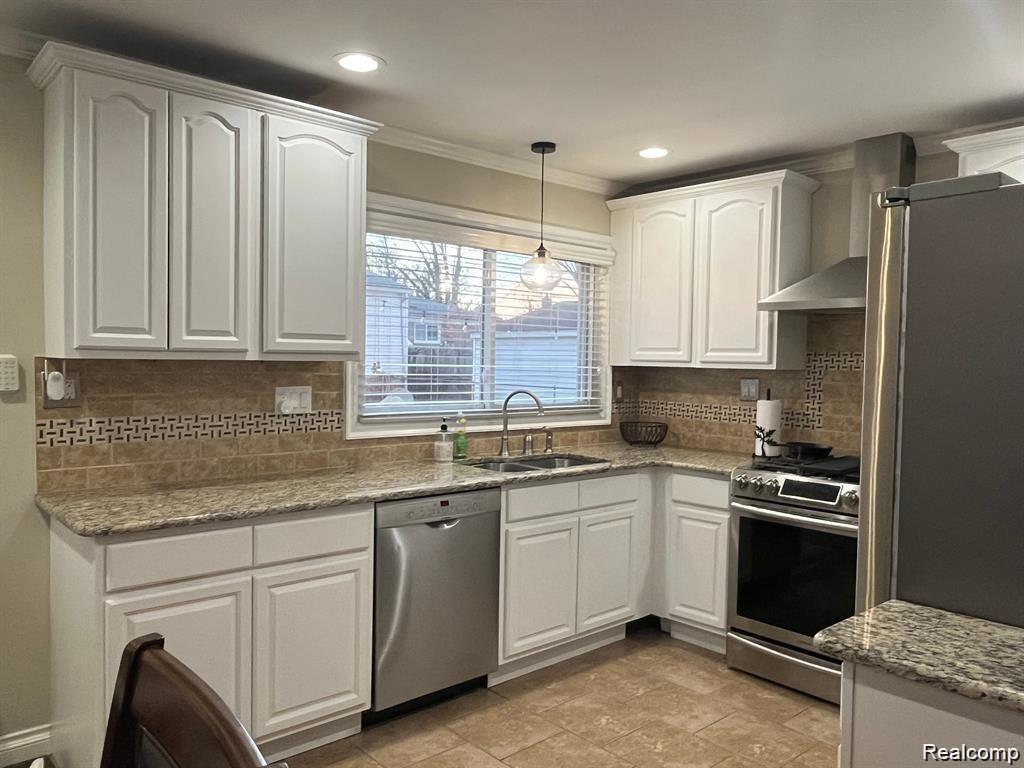 1341 Catalpa Drive Rochester, MI 48307 - Photo 2 of 9 Kitchen featuring white shaker-style cabinetry, a tiled backsplash with decorative inlay, and granite countertops