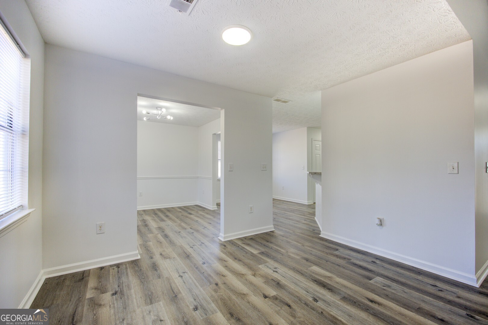 40 Brandon Drive Covington, GA 30016 - Photo 14 of 40 an empty room with wooden floor and windows