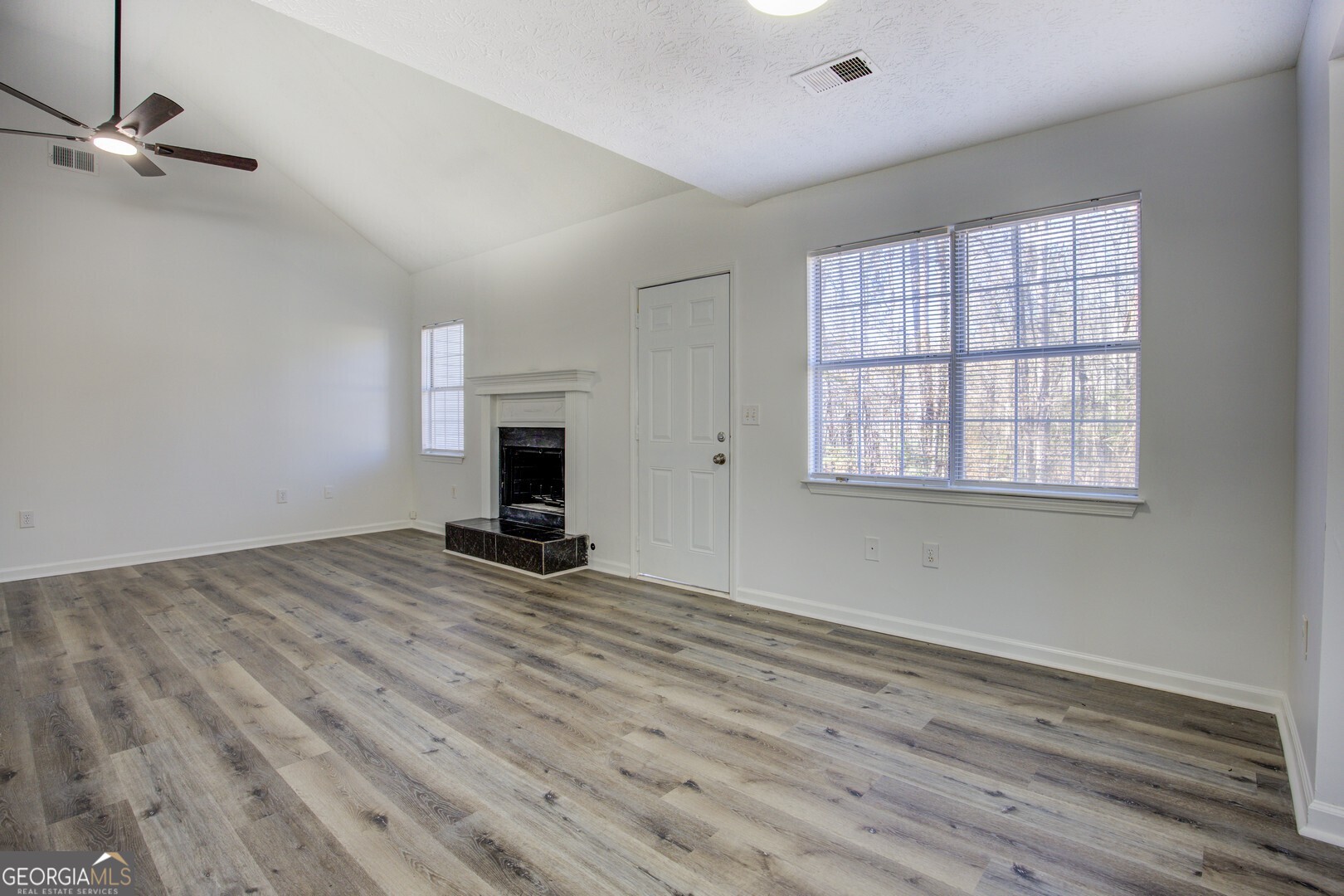 40 Brandon Drive Covington, GA 30016 - Photo 15 of 40 a view of empty room with wooden floor and fan