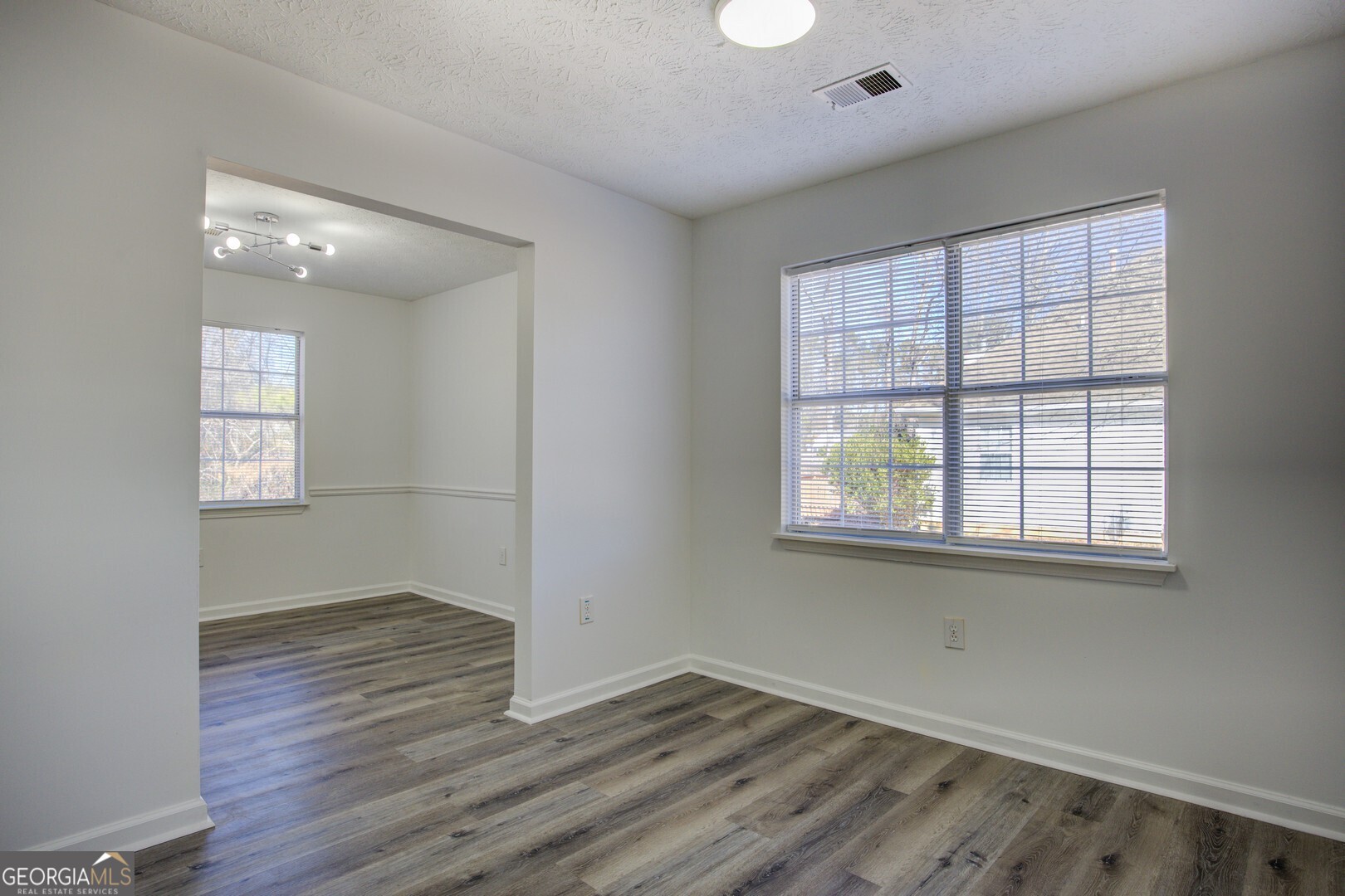 40 Brandon Drive Covington, GA 30016 - Photo 20 of 40 an empty room with wooden floor and windows