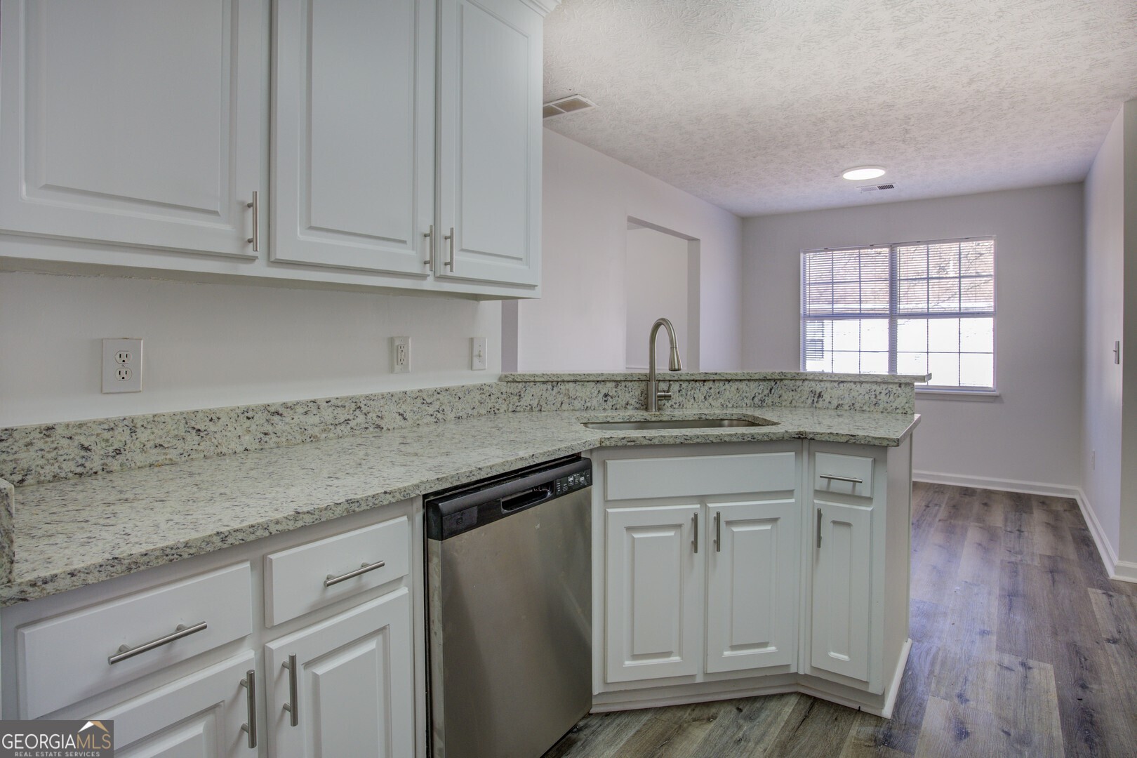 40 Brandon Drive Covington, GA 30016 - Photo 23 of 40 a kitchen with granite countertop a sink and cabinets