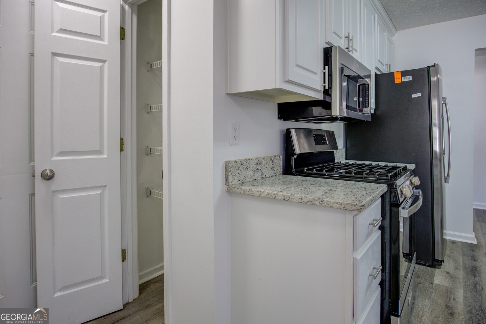 40 Brandon Drive Covington, GA 30016 - Photo 26 of 40 a kitchen with a refrigerator and a stove
