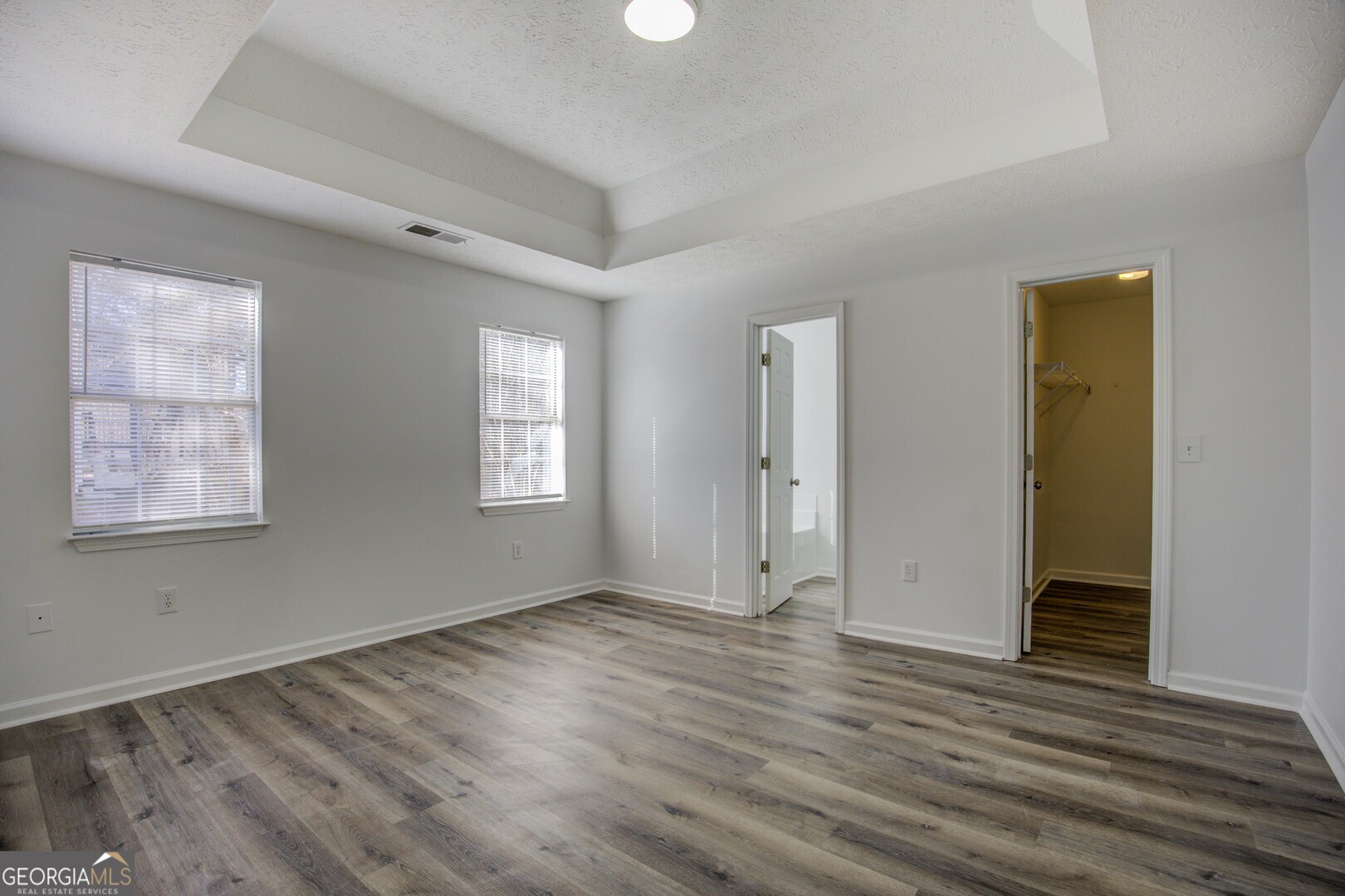 40 Brandon Drive Covington, GA 30016 - Photo 27 of 40 a view of an empty room with wooden floor and a window