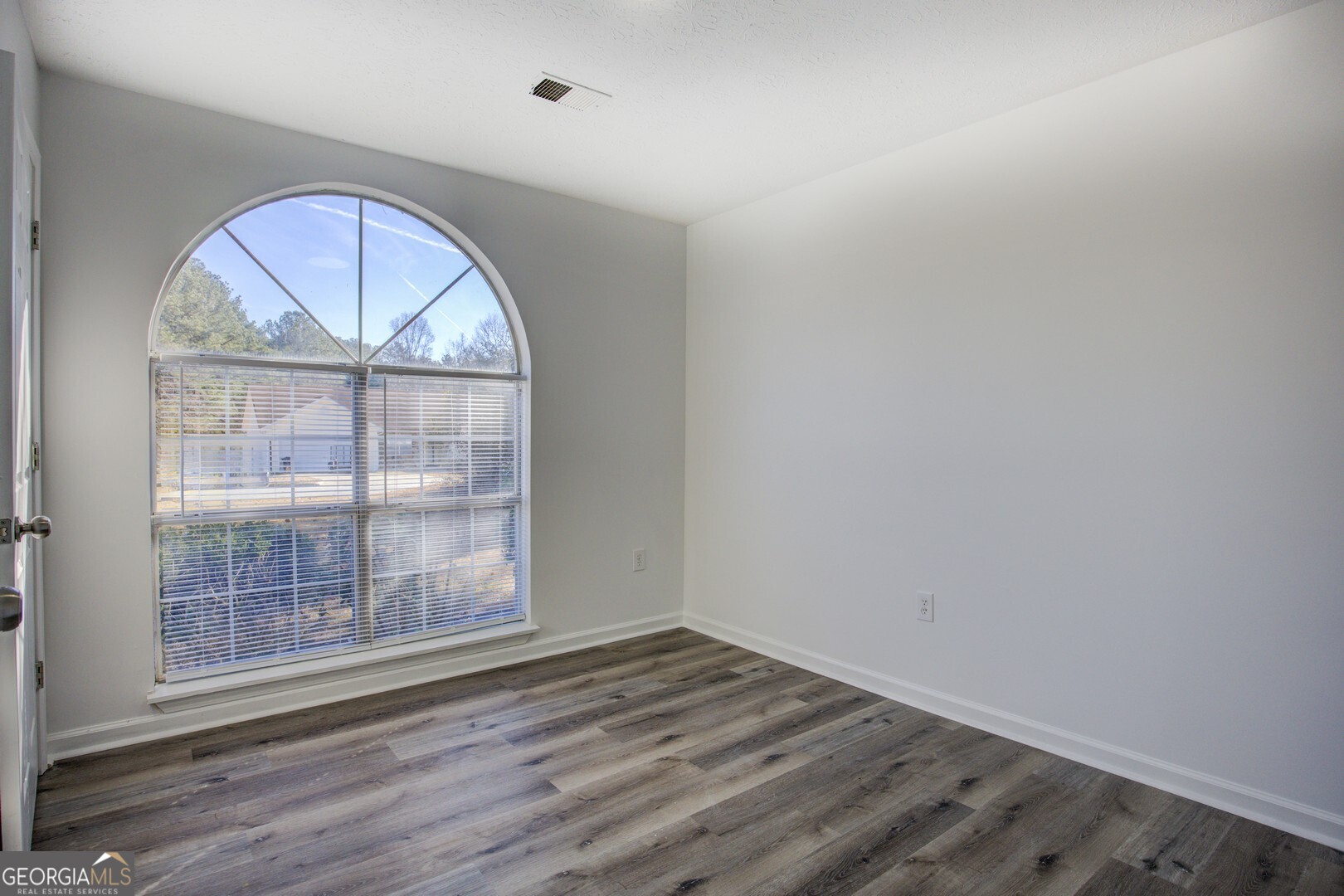 40 Brandon Drive Covington, GA 30016 - Photo 33 of 40 an empty room with wooden floor and a window