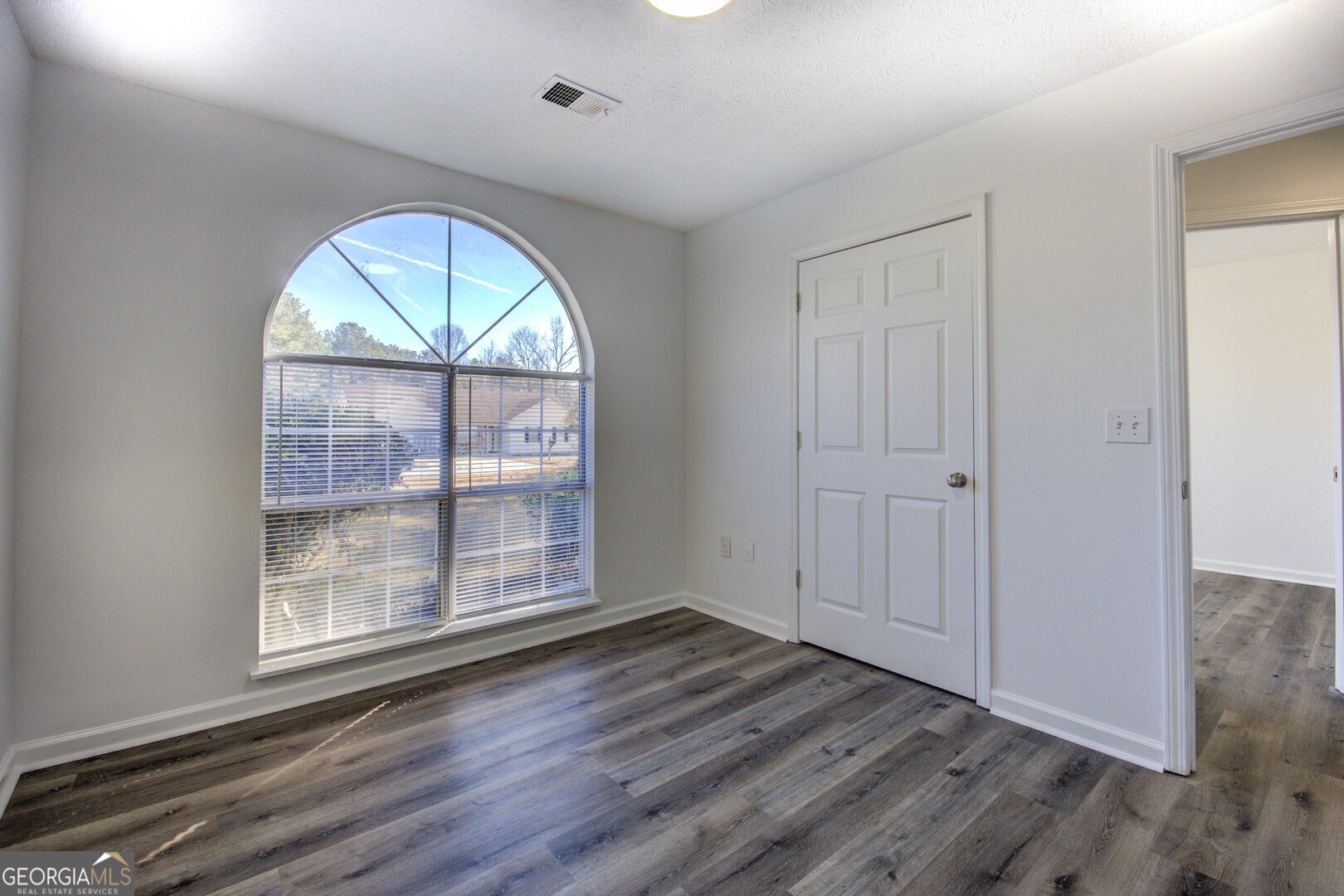 40 Brandon Drive Covington, GA 30016 - Photo 34 of 40 wooden floor in an empty room with a window