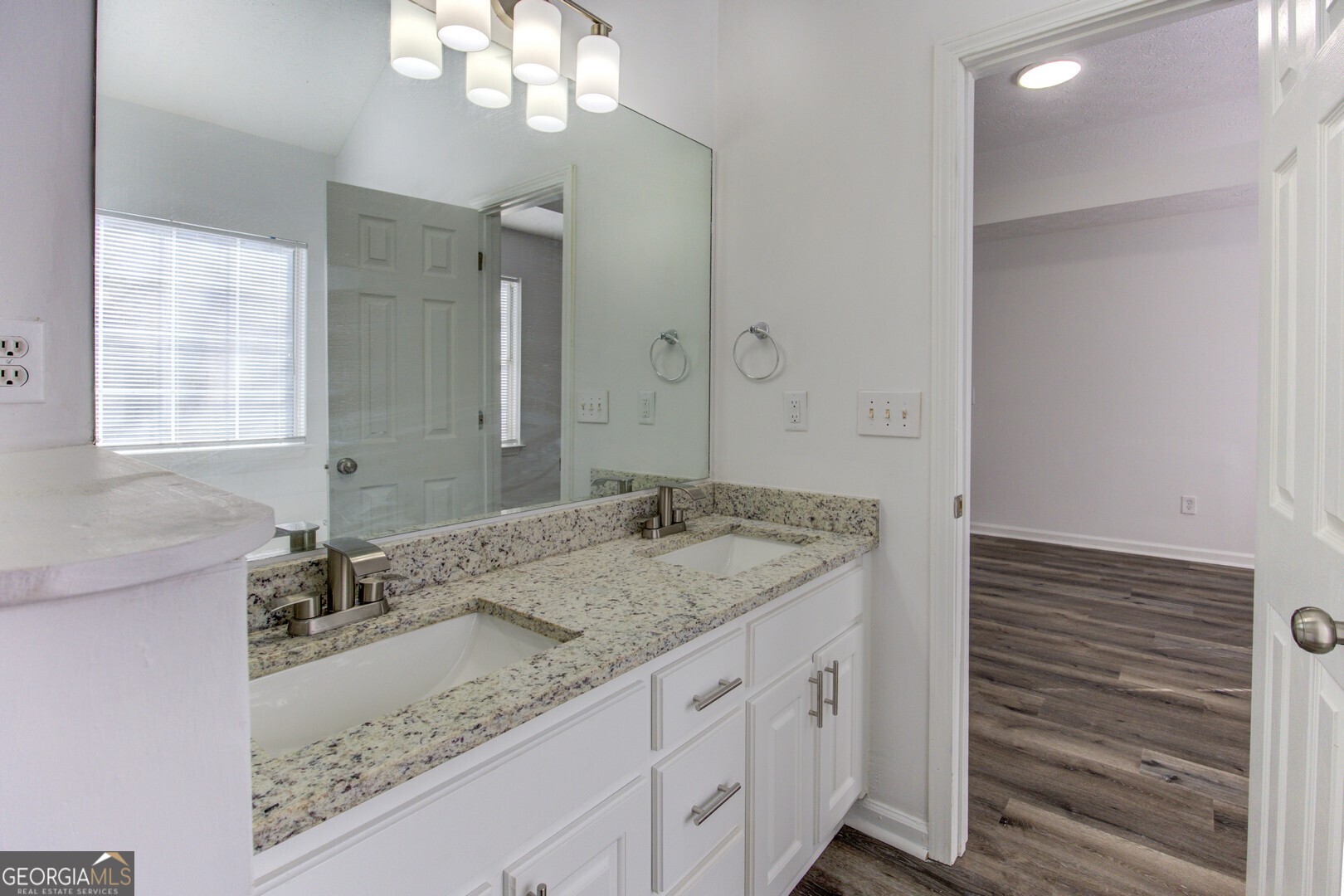 40 Brandon Drive Covington, GA 30016 - Photo 39 of 40 a bathroom with a granite countertop sink and a mirror