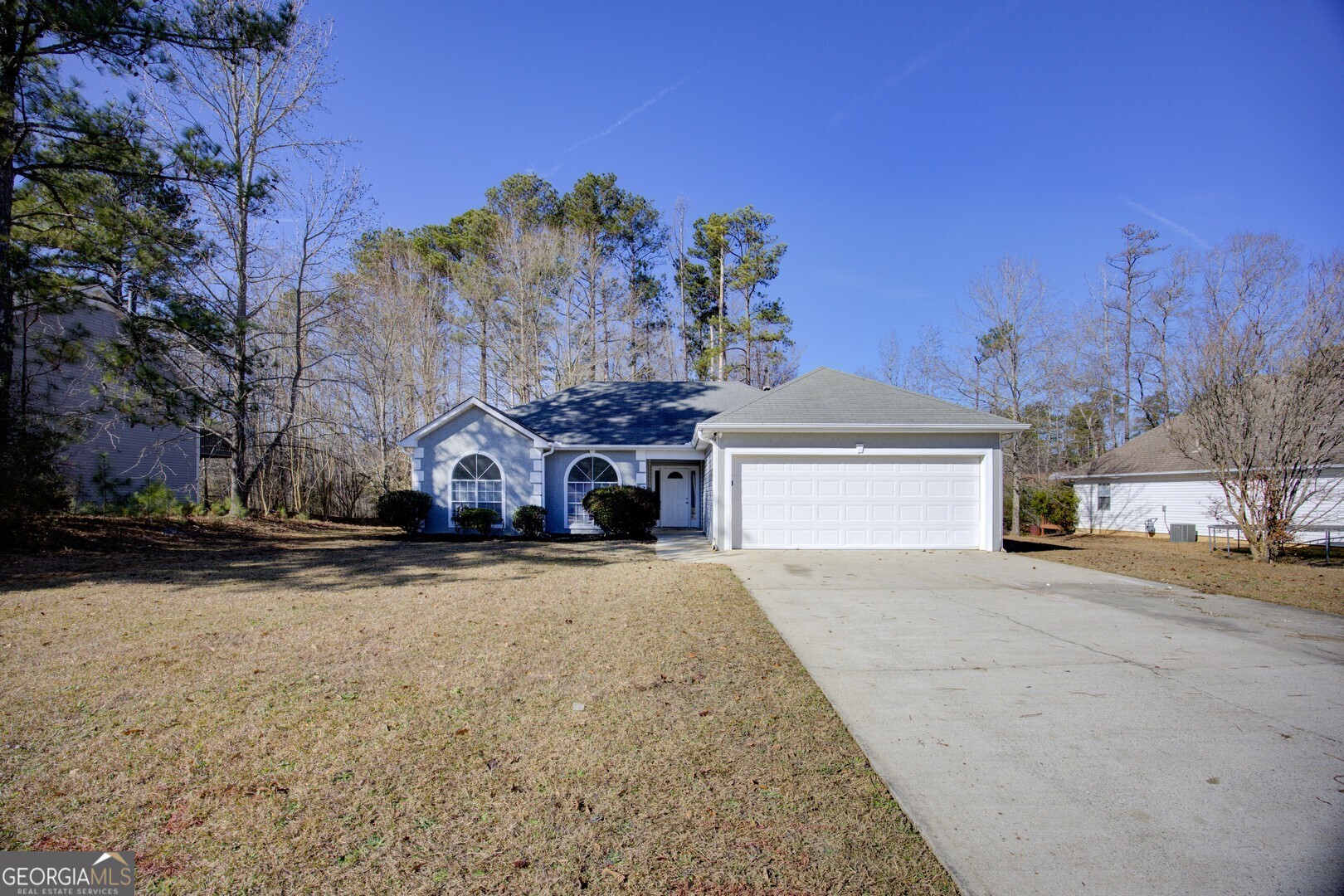 40 Brandon Drive Covington, GA 30016 - Photo 5 of 40 a front view of a house with a yard and garage