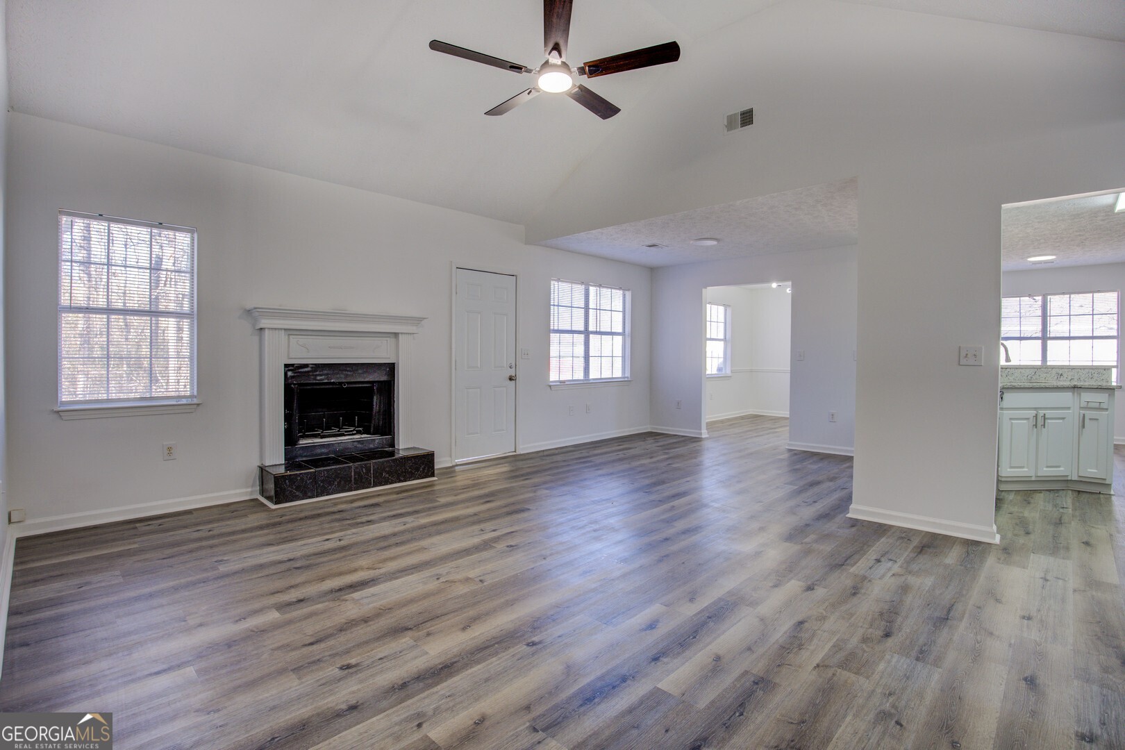 40 Brandon Drive Covington, GA 30016 - Photo 8 of 40 a view of an empty room with wooden floor fireplace and a window