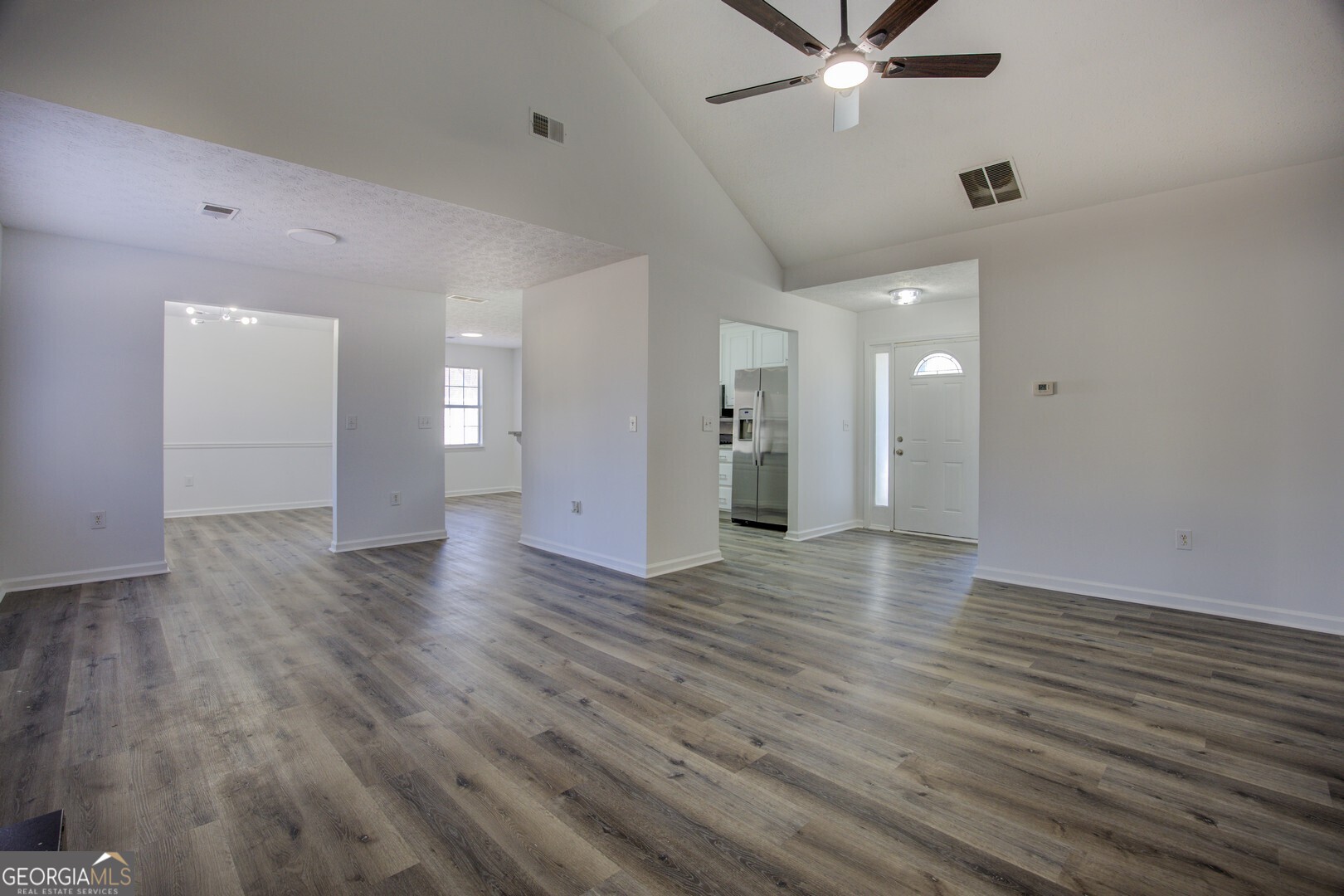 40 Brandon Drive Covington, GA 30016 - Photo 9 of 40 an empty room with wooden floor and ceiling fan