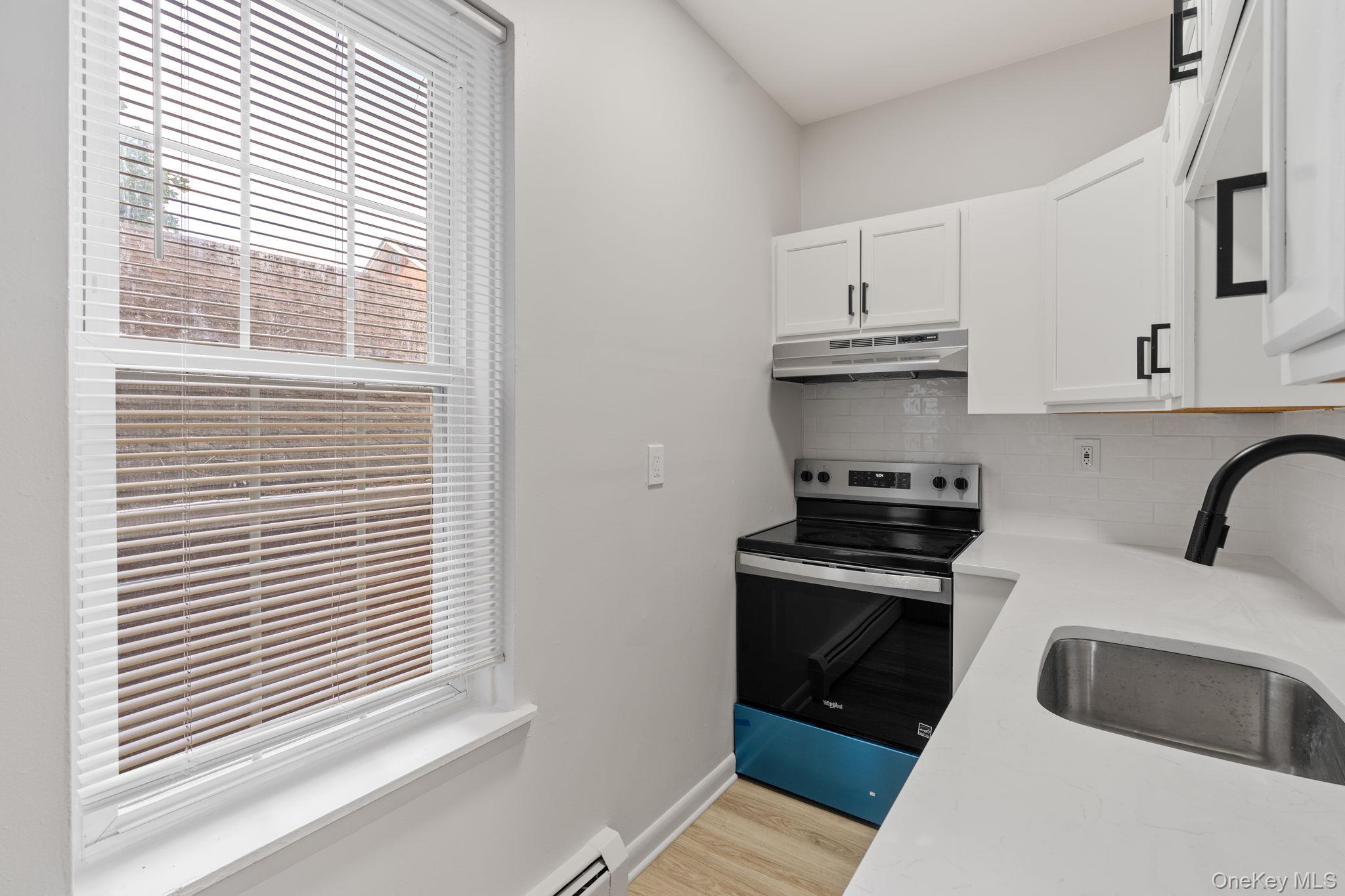 32 North Bridge Street Poughkeepsie, NY 12601 - Photo 10 of 19 a kitchen with stainless steel appliances granite countertop a stove and a refrigerator