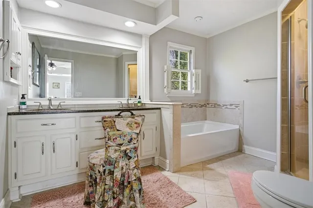 a bathroom with a bathtub sink and mirror