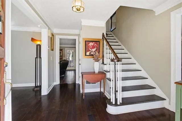 a view of entryway and hall with wooden floor