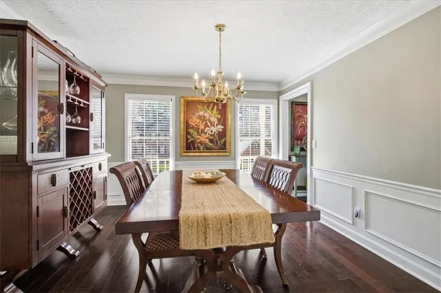 a view of a a dining room with furniture window and wooden floor