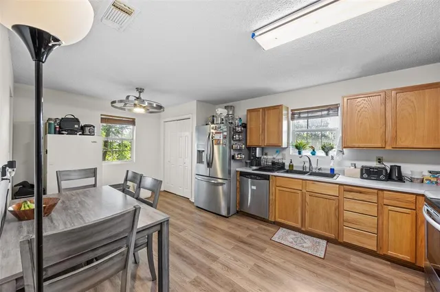 a kitchen with sink cabinets and wooden floor