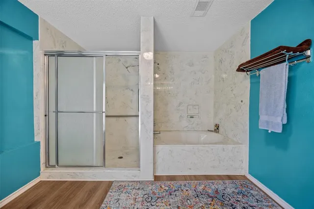 a bathroom with a bathtub and a shower