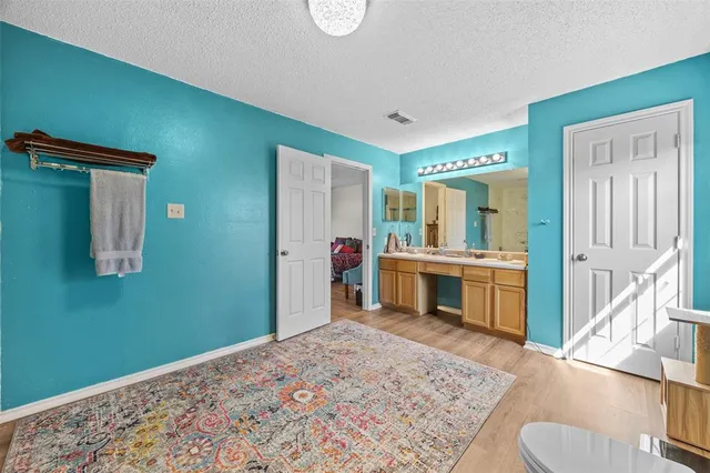 a bedroom with furniture and a wooden floor