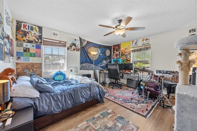 a living room with furniture a rug and wall paintings